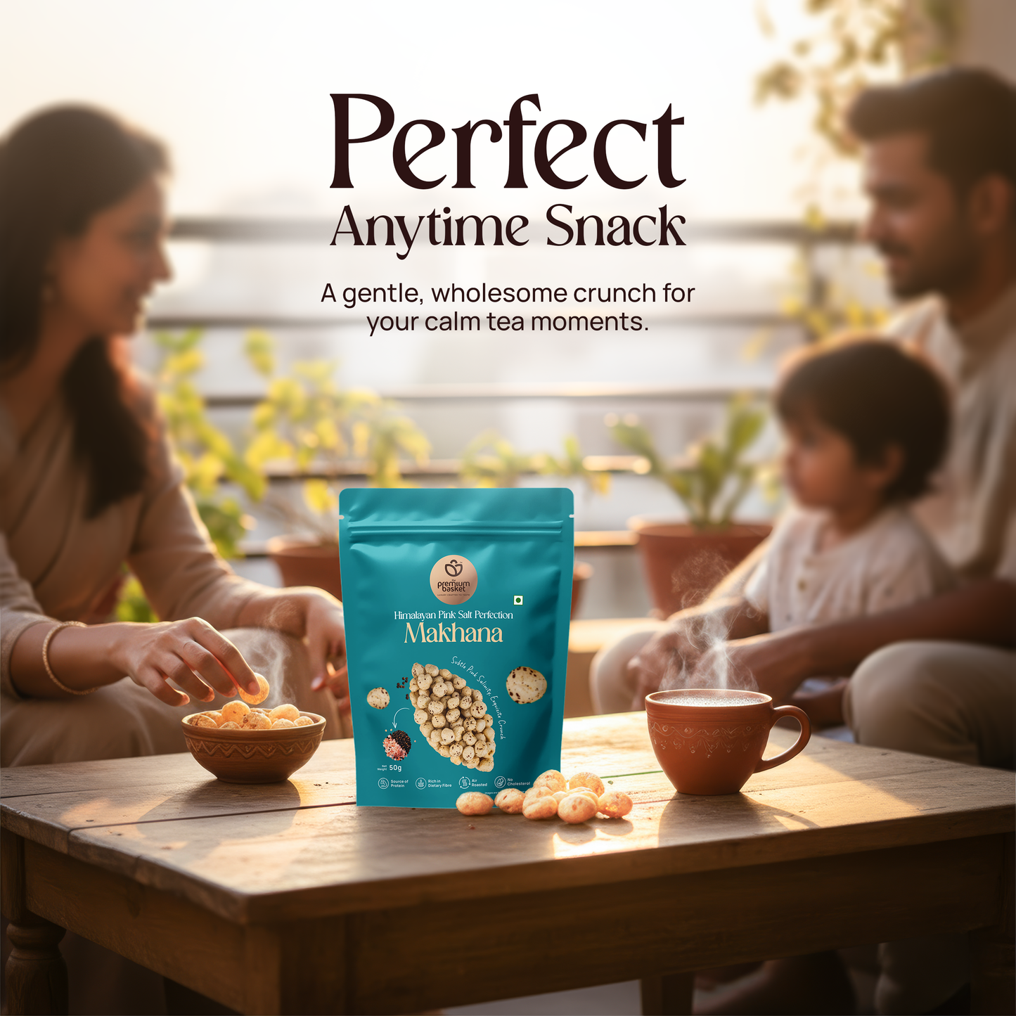 Teal makhana snack pouch on a table with snacks and tea cups