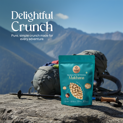 Teal makhana snack pouch standing on a rocky surface near outdoor gear